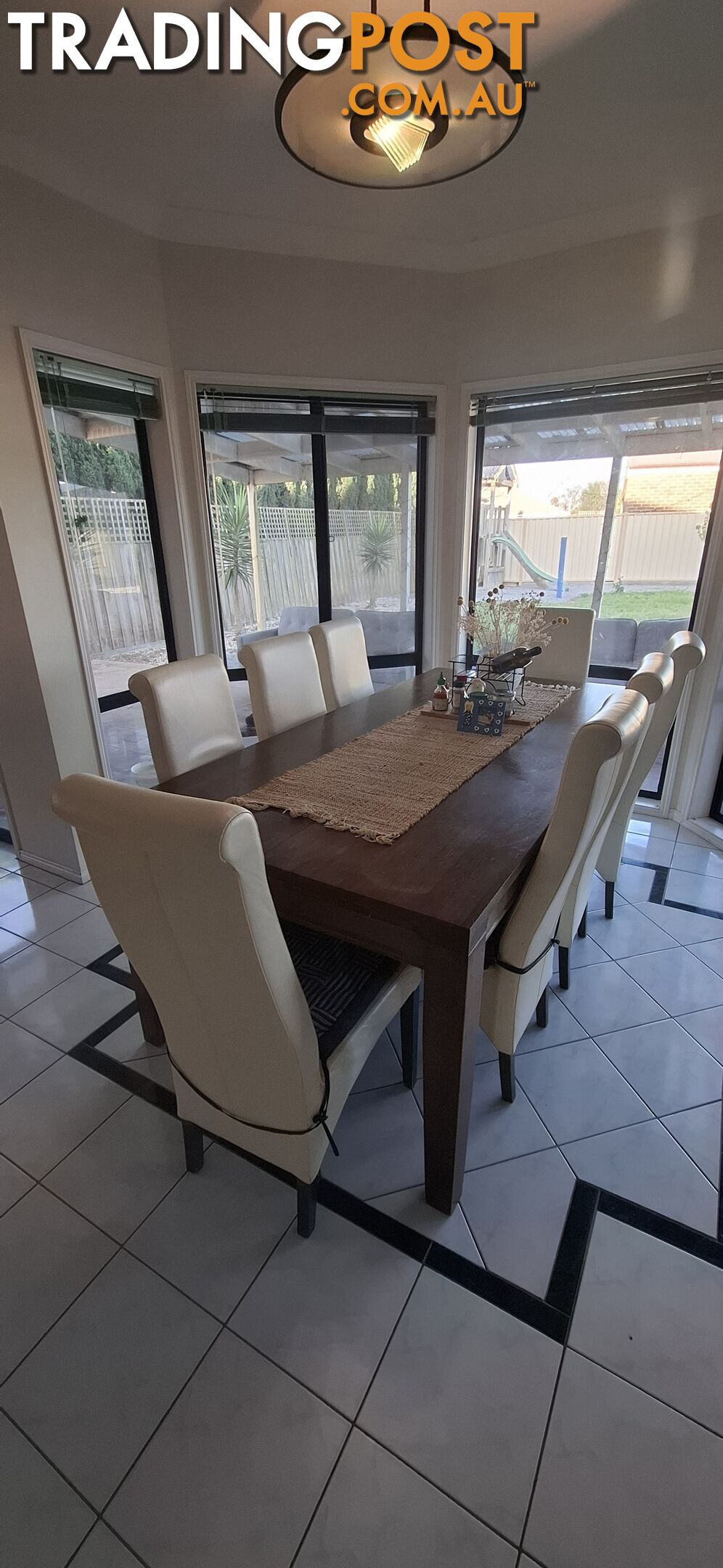 a dining table with 8 leather chairs.