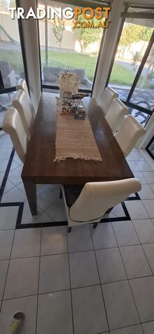 a dining table with 8 leather chairs.