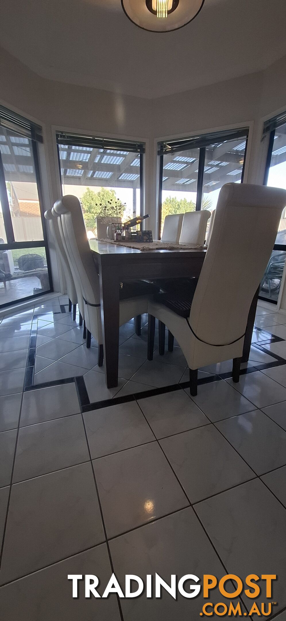 a dining table with 8 leather chairs.