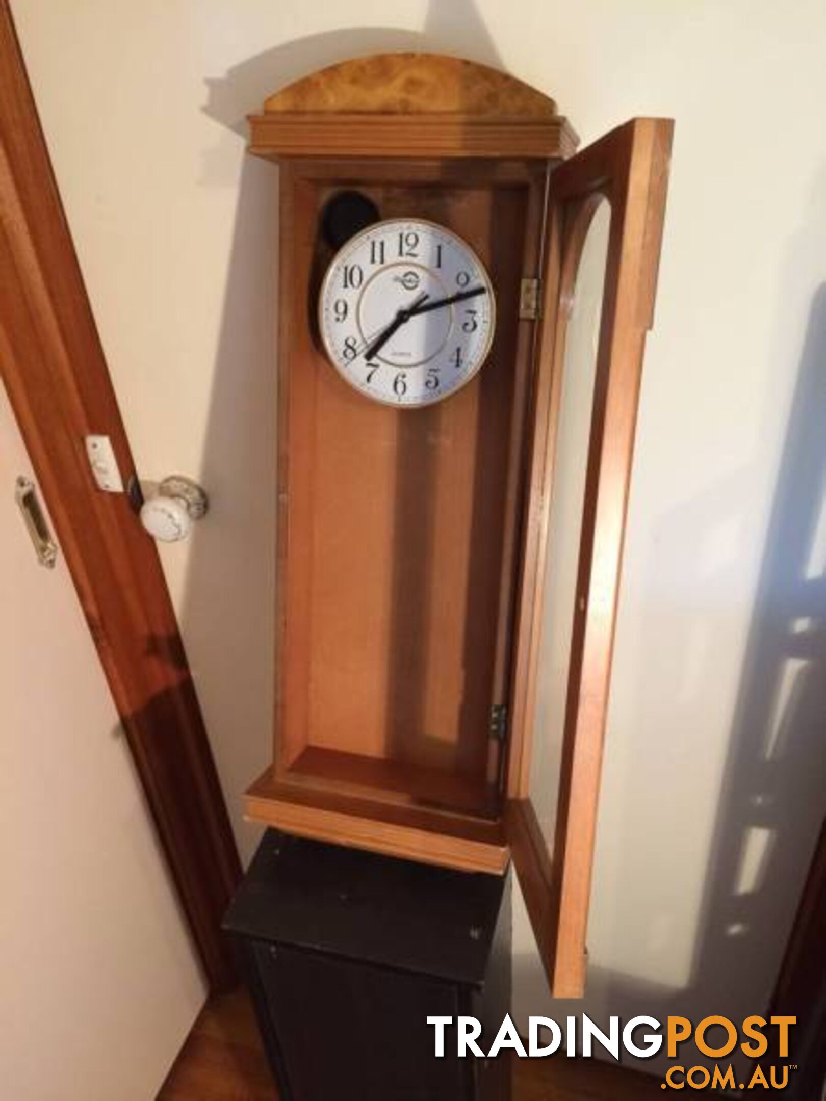 WALL MOUNTED CLOCK IN WOODEN CASE WITH GLASS DOOR