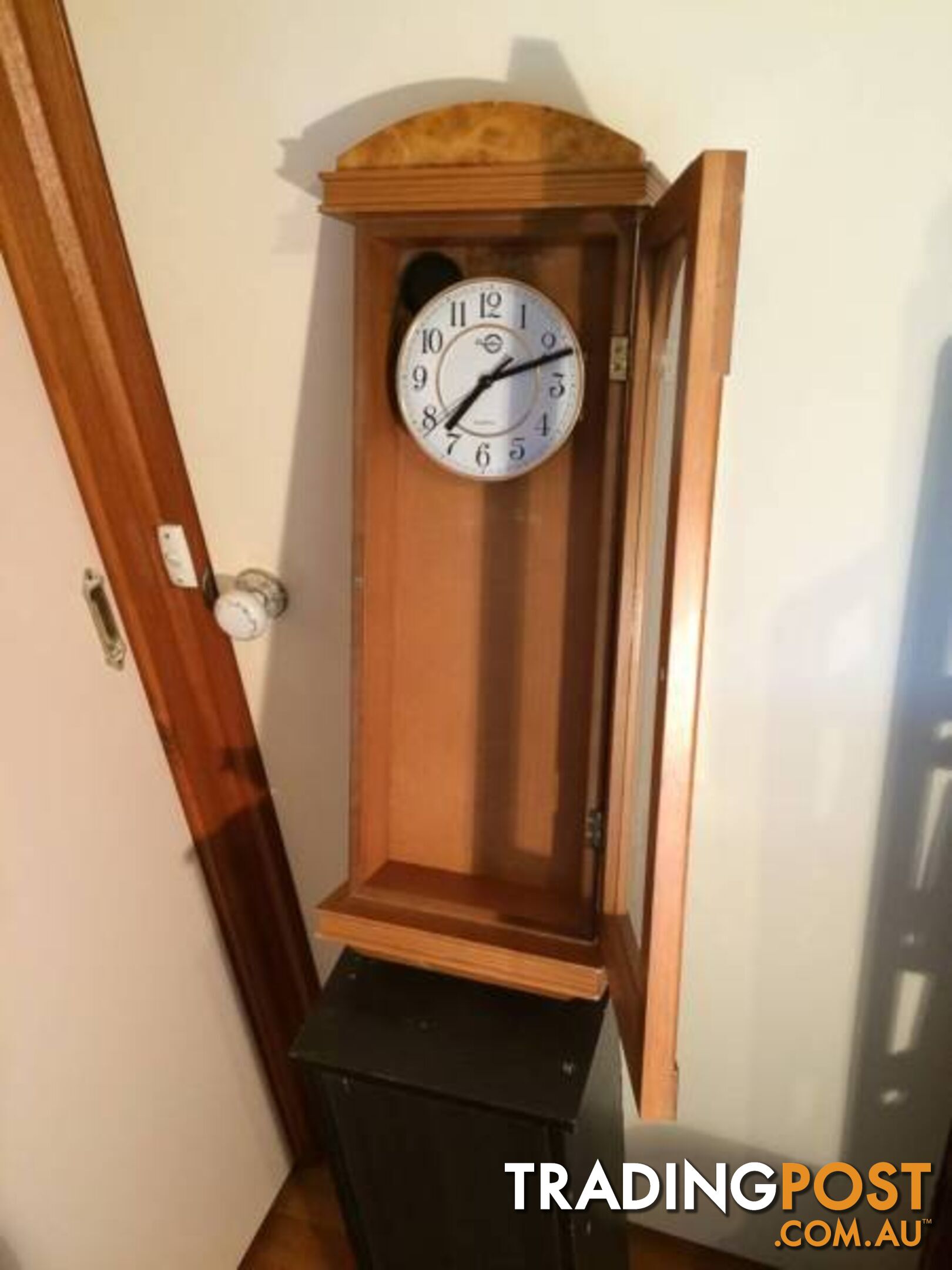 WALL MOUNTED CLOCK IN WOODEN CASE WITH GLASS DOOR