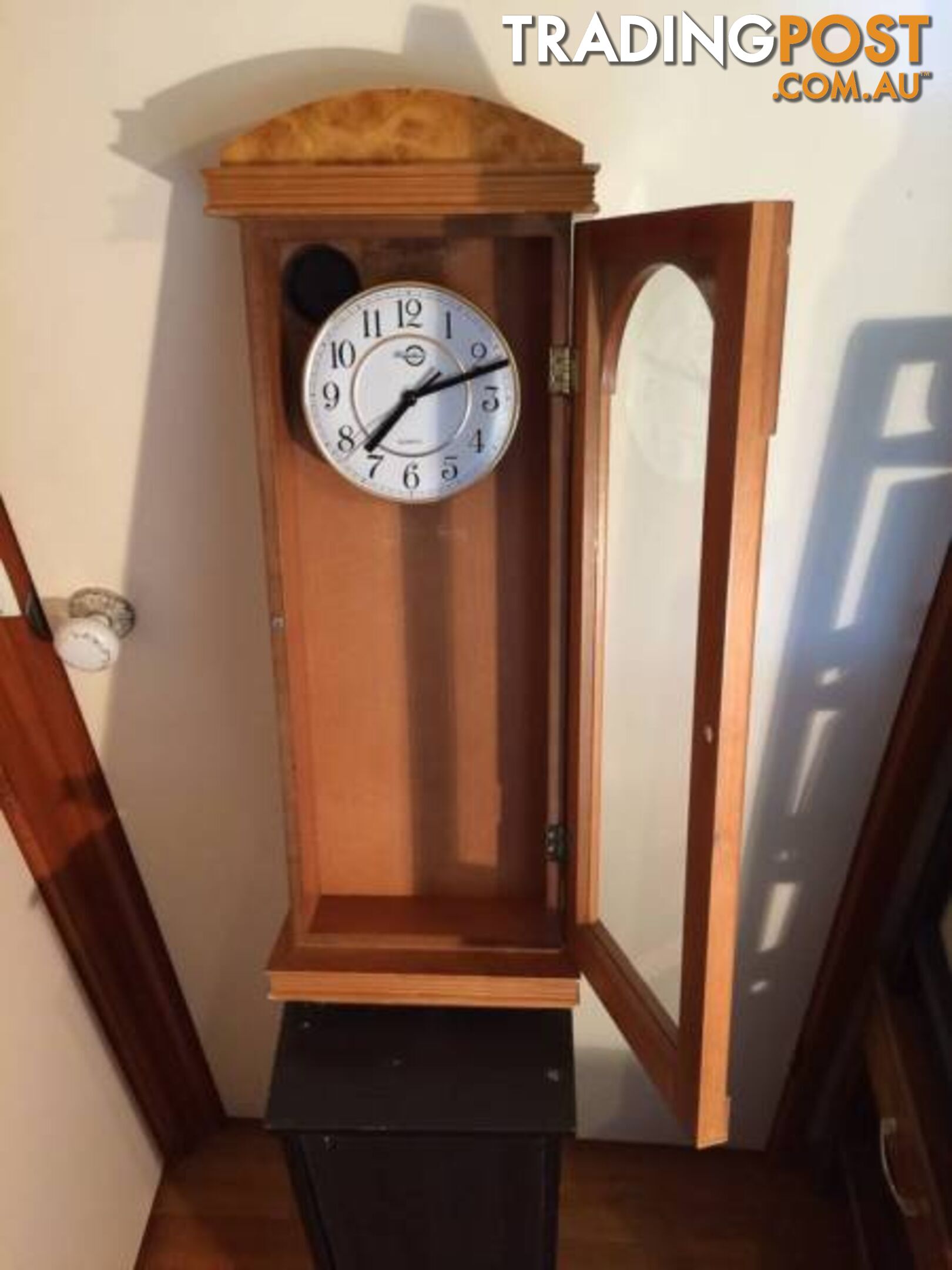 WALL MOUNTED CLOCK IN WOODEN CASE WITH GLASS DOOR