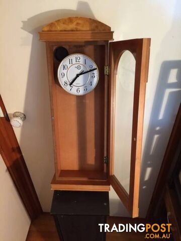 WALL MOUNTED CLOCK IN WOODEN CASE WITH GLASS DOOR