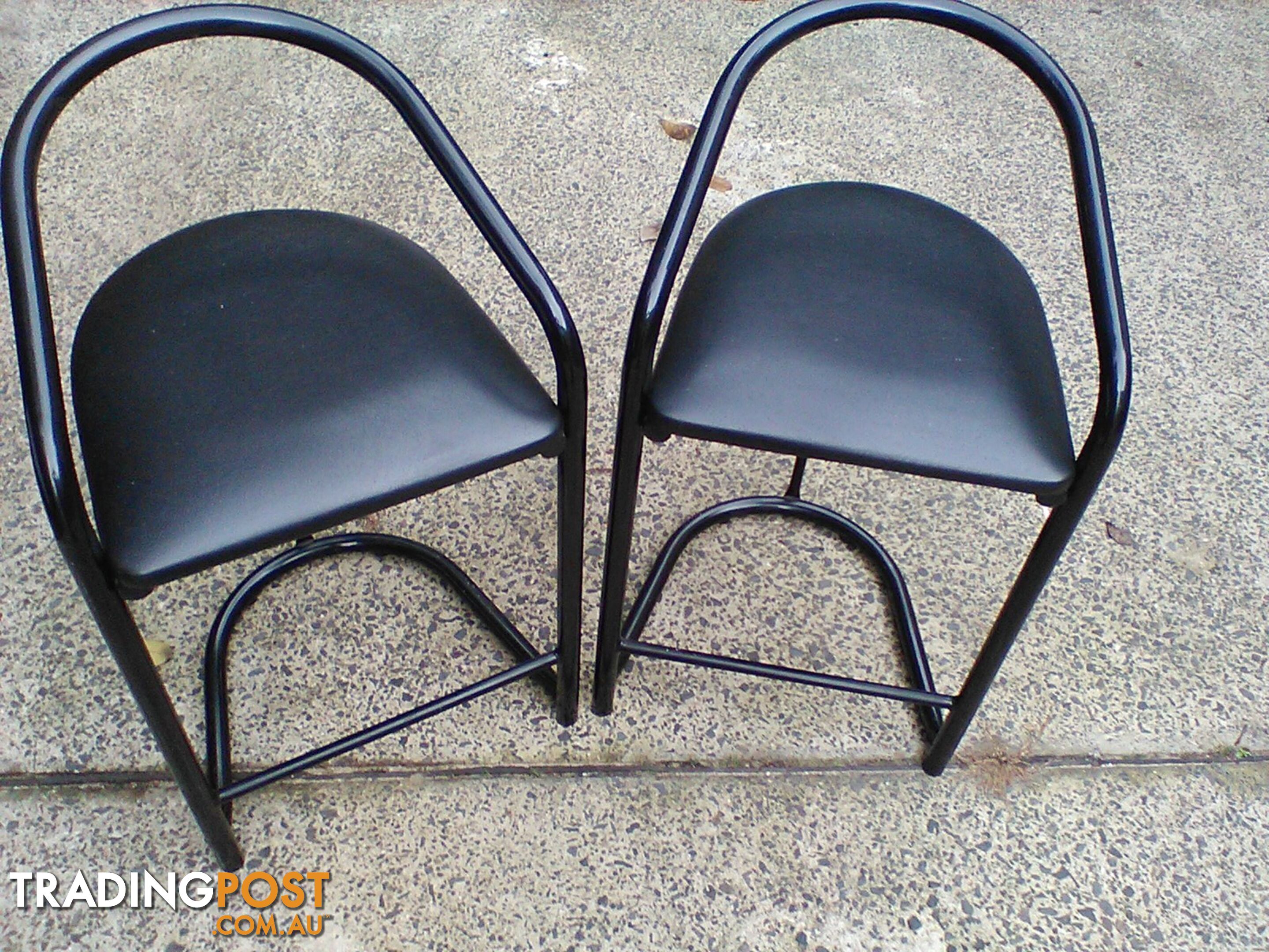 Four black bar stools