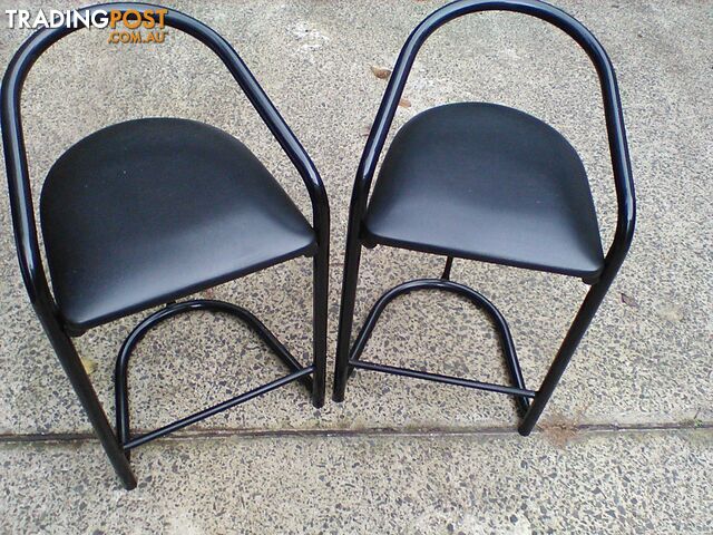 Four black bar stools