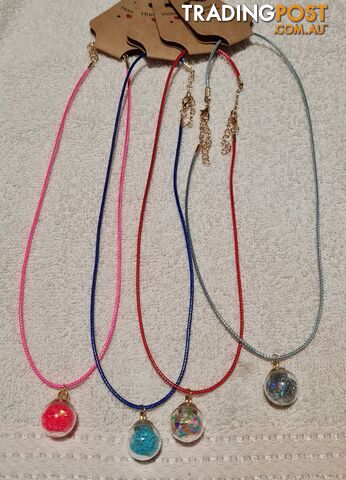 Homemade coloured nylon necklaces with pendents