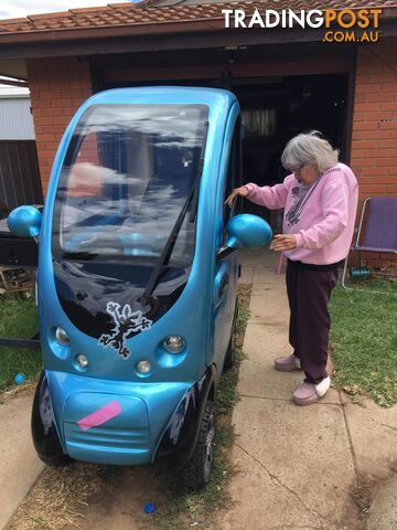 All weather fully enclosed electric mobility scooter