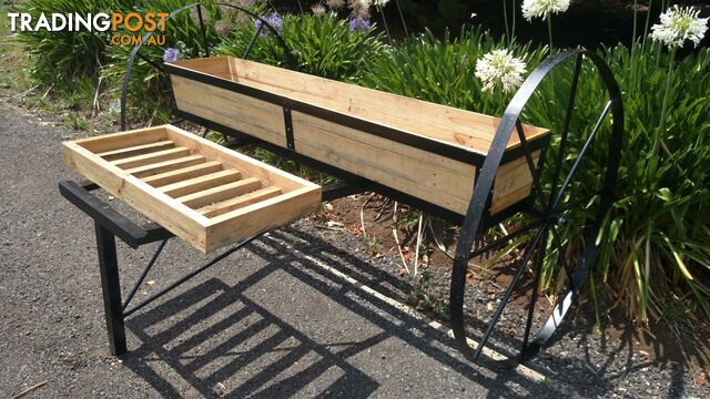 Planter box on wagon wheels. Garden Art