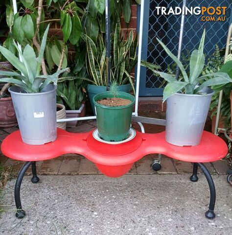 Red bench for flowers in pots