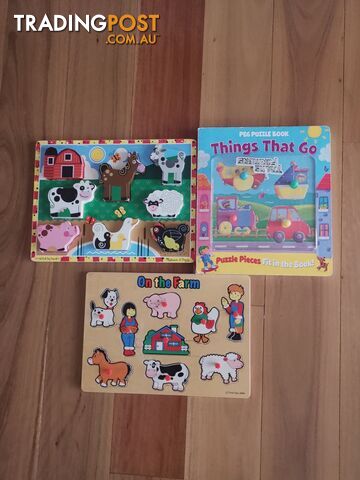 One puzzle book and two puzzle toys.