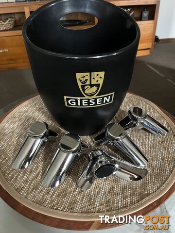 5 Georg Jensen stainless steel bottlestoppers. 5 piece. And a Giesen winery wine...
