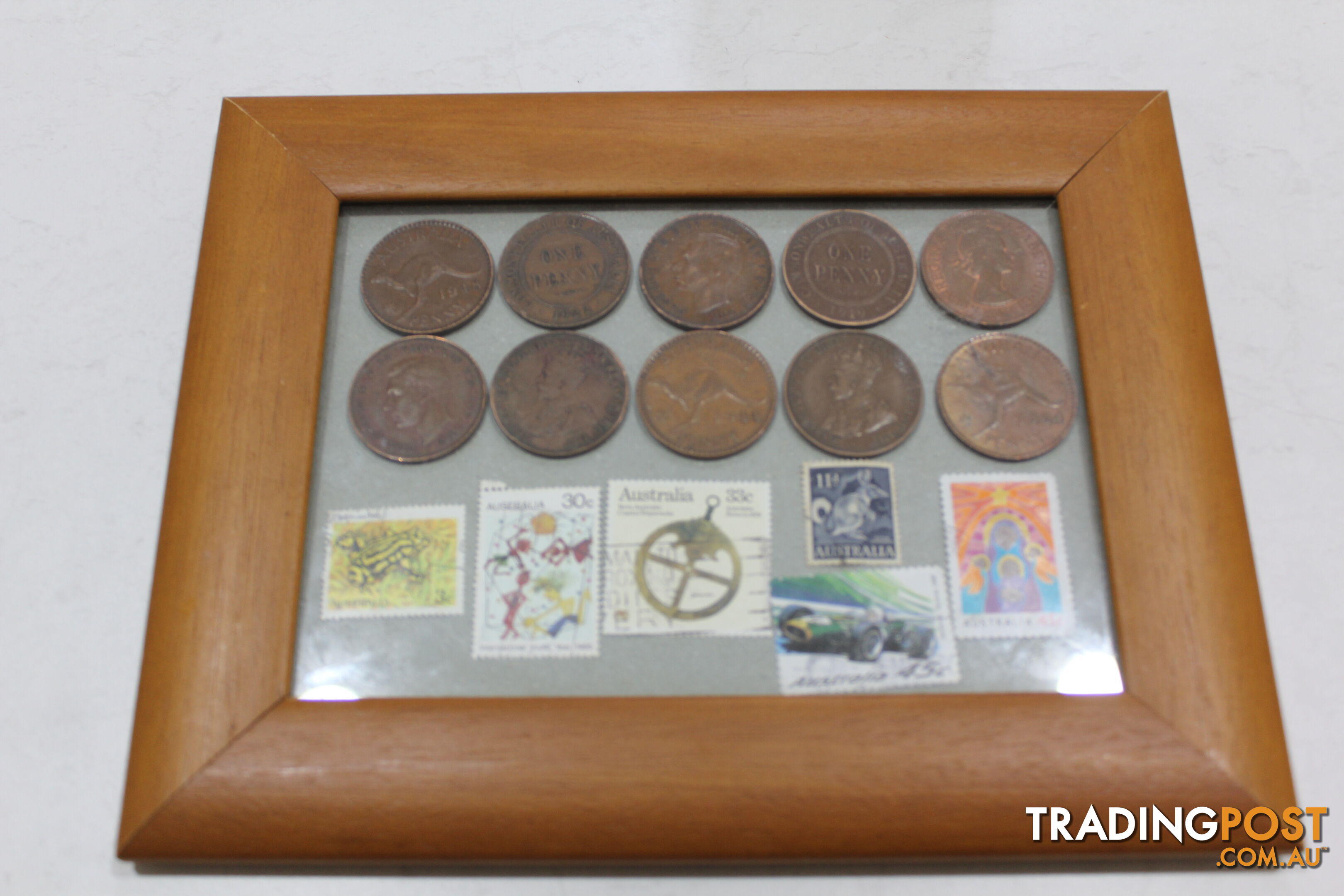 Penny&amp;#39;s and old stamps in picture frame