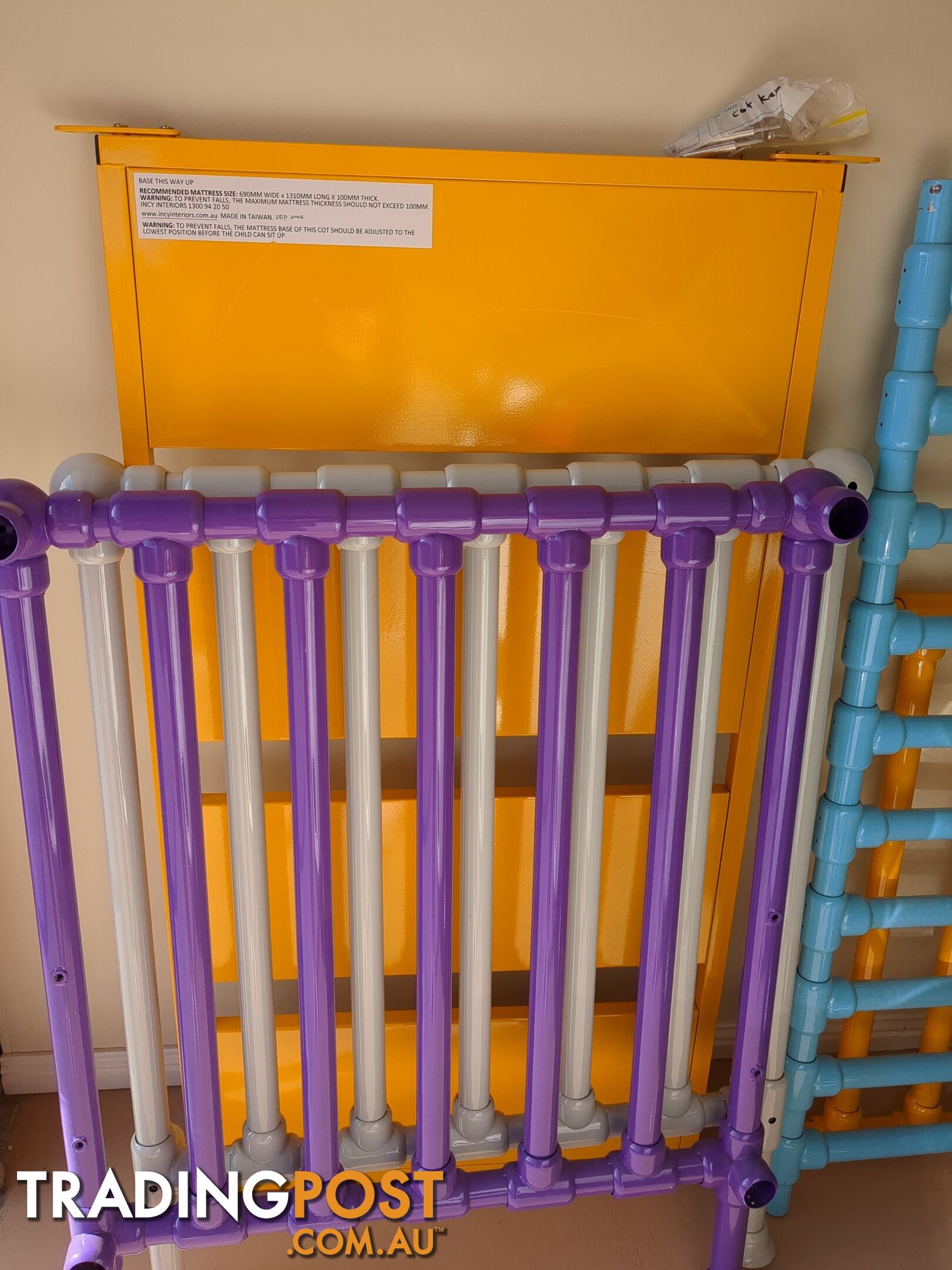 Bright, multicolor metal cot.