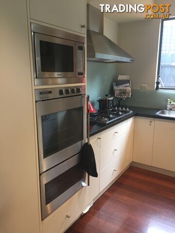 Large kitchen with island bench and appliances