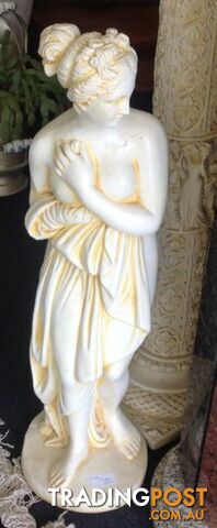 Garden statue of lovely Grecian goddess lady on pedestal