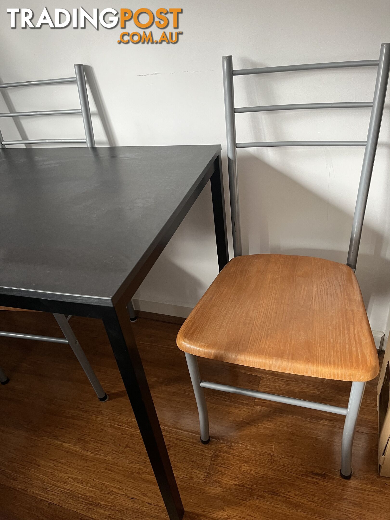 Black dining table with four chairs