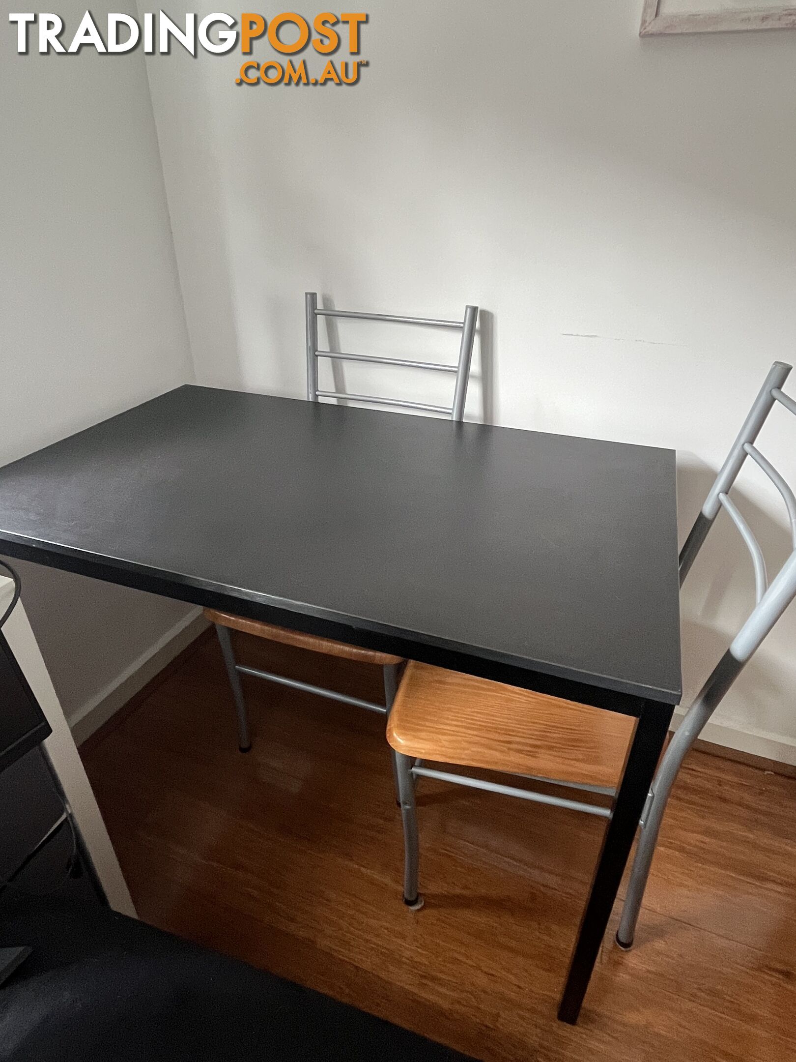 Black dining table with four chairs